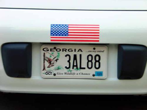 Atlanta Georgia -- License plate and flag on the back of the car as Round America 2003 Day 1 begins in Atlanta Georgia - 2003-04-01